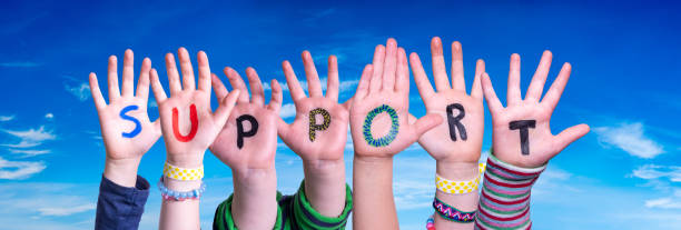 istock Children Hands Building Word Support, Blue Sky 1219594214