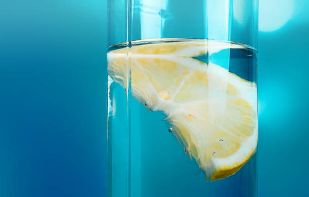 istock Lemon slice in a glass of water on a bright background 1219595263