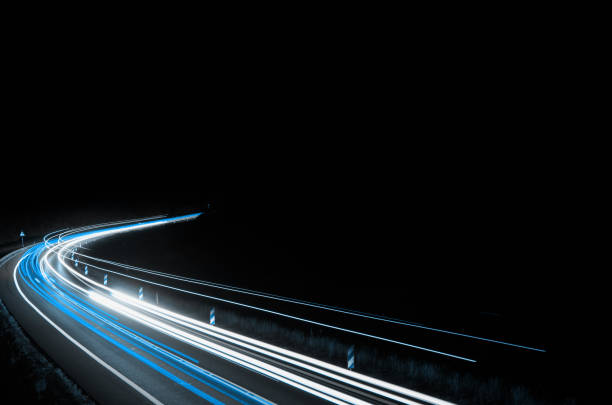 istock blue car lights at night. long exposure 1219595409