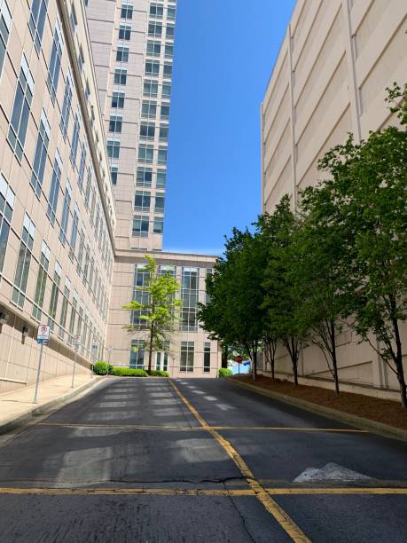 istock Uphill road between two buildings with landscaping 1219596484