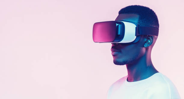 istock Web banner of young african man wearing virtual reality headset. VR concept. 1219598126