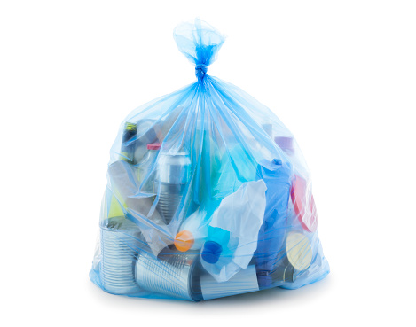 Blue recycling bag full of mixed materials paper, plastic, glass and metal isolated on white