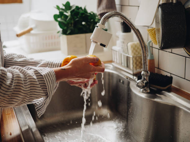 istock Young woman preparing squeezing orange juice at home. 1219598307