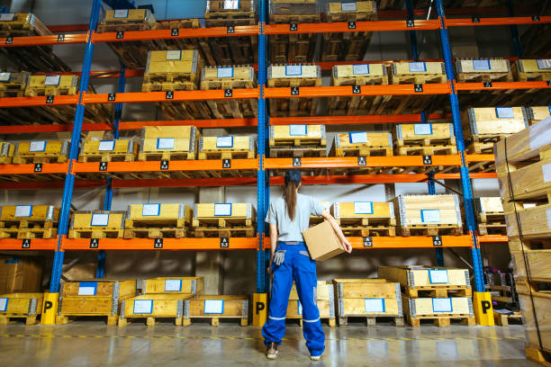 istock Young female manual worker standing inside warehouse 1219600640