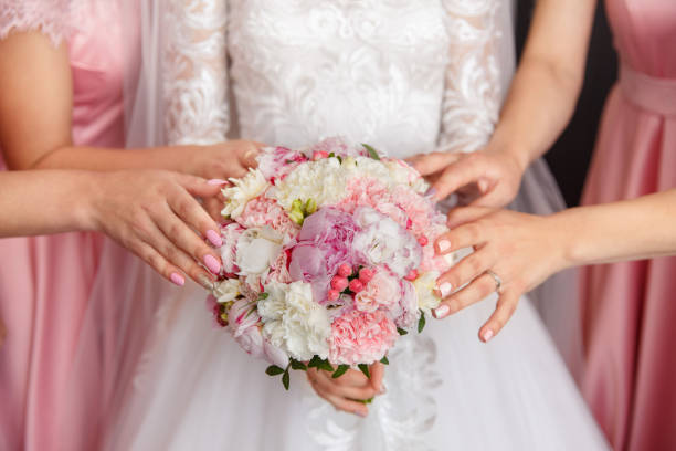 istock Bride and bridesmaids holding wedding bouquet 1219602296