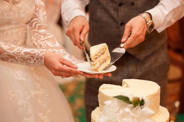 istock Bride and groom cut wedding cake 1219602490