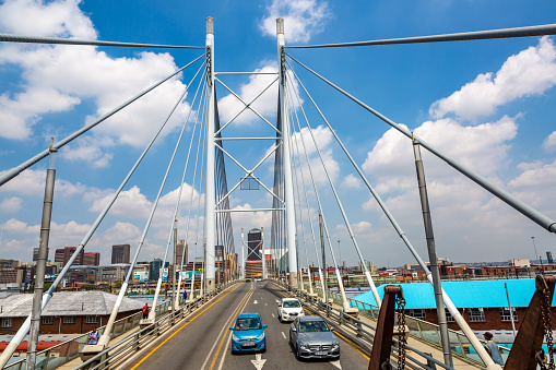 This pic shows Nelson Mandela Bridge in Johannesburg with moving traffic and cars on the bridge. The pic is taken in day time and in march 2019.