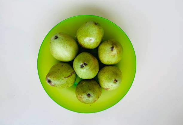 Seven pears in green bowl
