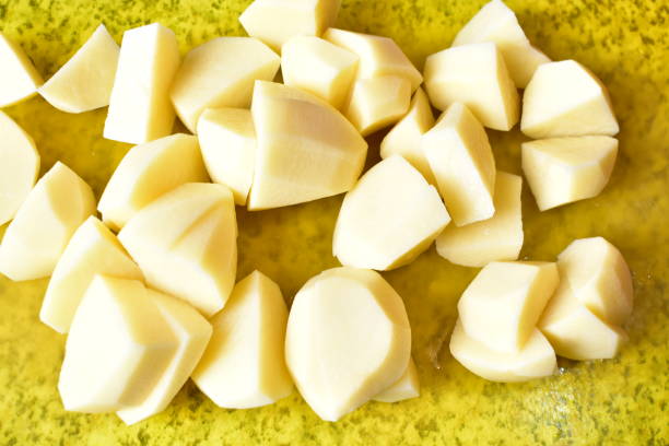 istock Sliced fresh potatoes and cutting them with a knife 1219604206