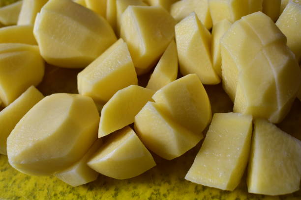 istock Sliced fresh potatoes and cutting them with a knife 1219604258