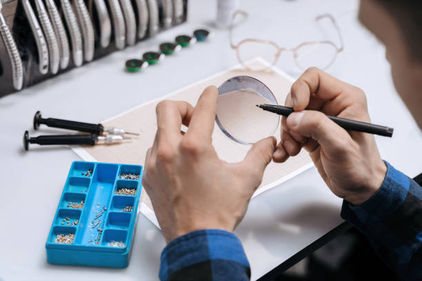 Closeup of man's hands marking lens for eyeglasses Young professional optometrist is working with lens in optical workshop using special tools and equipment. Vision concept ophthalmologist photos stock pictures, royalty-free photos & images
