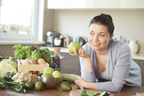 istock woman in the kitchen preparing food 1219606313