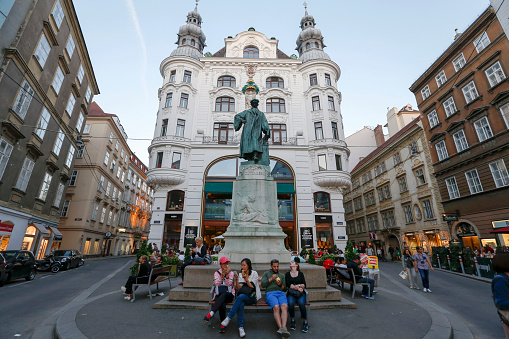 Vienna, Austria - may, 27, 2017 -  tourists rest  in the square in front of with Johannes Gutenberg Memorial. Vienna, Austria