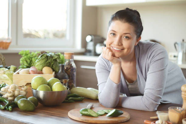 istock woman in the kitchen preparing food 1219607265
