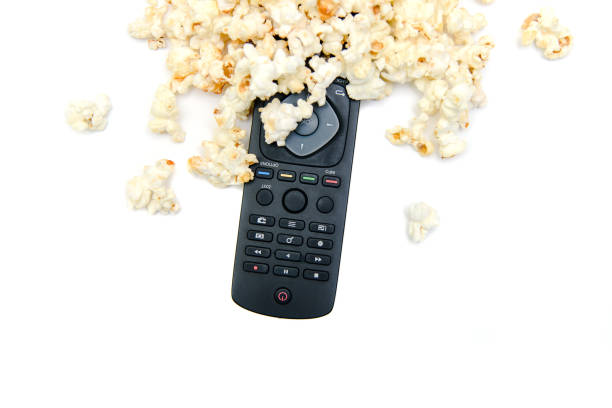 istock Popcorn and tv remote control on white background. Watching TV concept. 1219608327