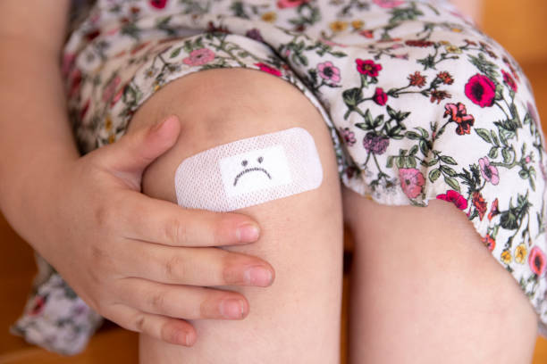 그녀의 무릎에 밴드 원조와 어린 소녀 - adhesive bandage child physical injury human knee 뉴스 사진 이미지