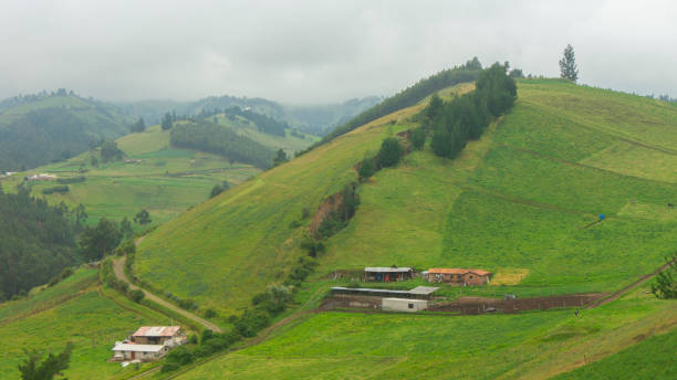 istock Ecuadorian range landscape with mountains with green fields planted, trees and small houses 1219608811