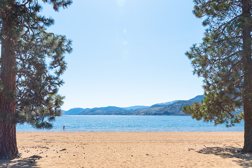 View of Skaha Lake and Skaha Beach on sunny afternoon in Penticton, British Columbia, Canada.