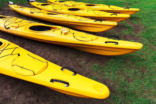 kayaks lie on the green lawn