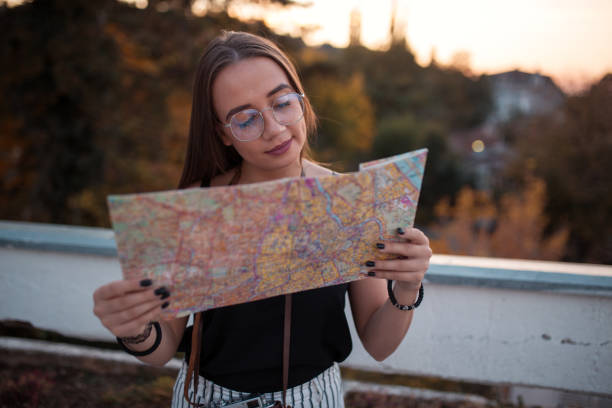 istock Young tourist looking at city map 1219610546