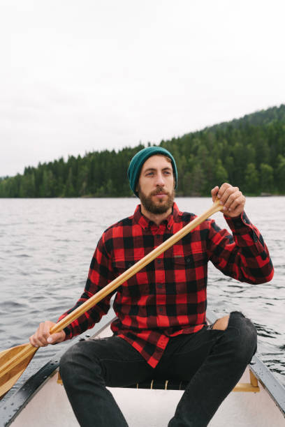 istock Man canoeing on lake in Finland 1219611727