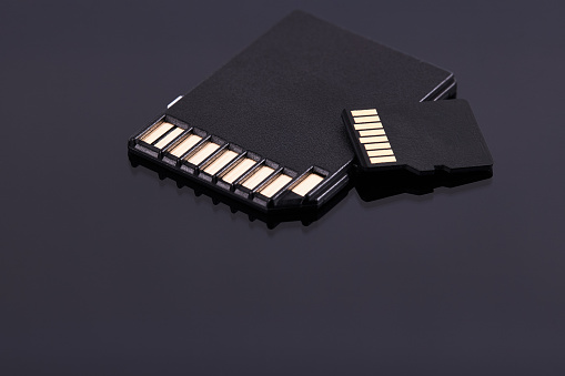Micro and SD storage memory cards isolated on black background. different storage technologies.