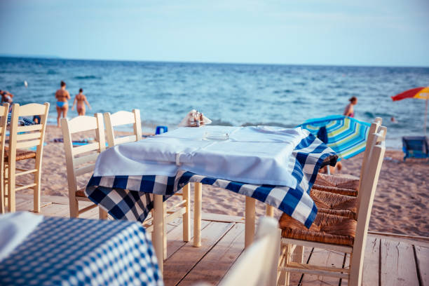 istock Table and chairs at blue sea background 1219614841