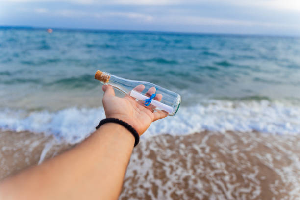 istock Message in a glass bottle in hand 1219615692