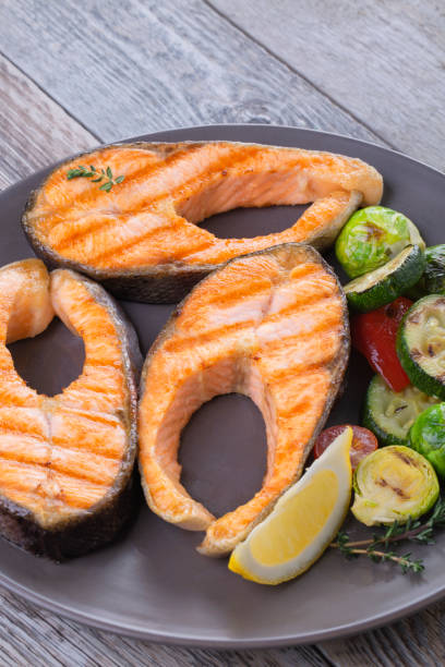 istock Three grilled salmon steaks with mix of vegetables 1219615733