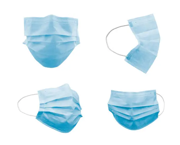 Photo of Collection of Blue Medical Face Masks At Different Angles Isolated on White