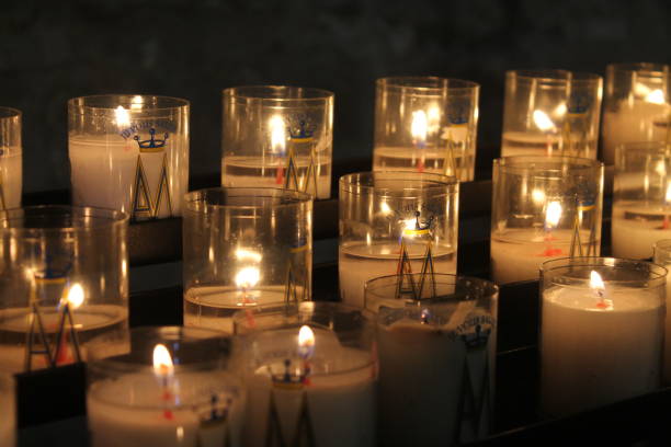 istock Lighting candles at Saint-Pierre de Montmartre Church 1219623839