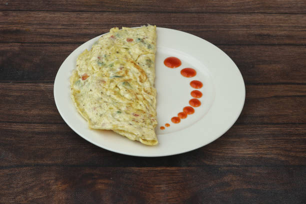 Masala omelet Or omelett Masala Omelette Or omelet served in white dish on wooden background. Selective focus masala stock pictures, royalty-free photos & images