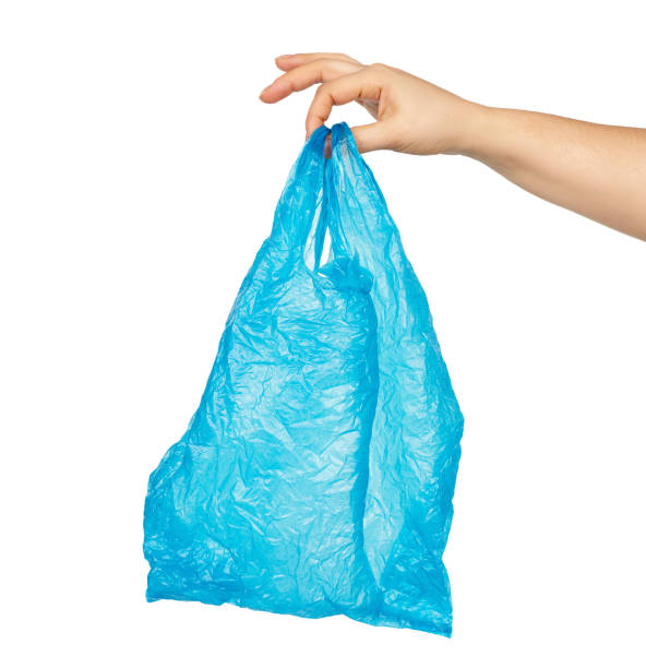 istock hand holds an empty blue plastic bag on a white background, concept of rejection of plastic 1219624746