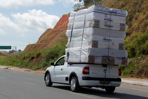 salvador, bahia / brazil - february 6, 2013: small pickup truck transits with a load of collections along Avenida Luiz Eduardo Magalhaes, in Salvador