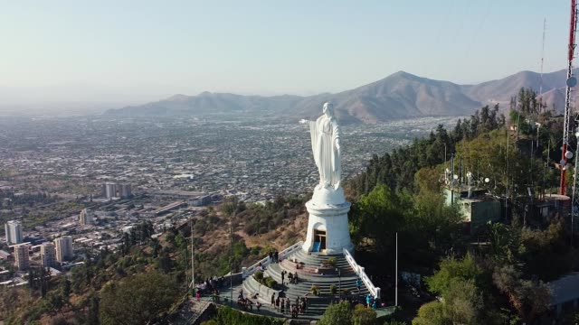 Aerial drone fly around Virgin Mary statue in Santiago