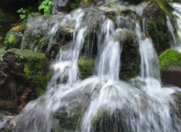 Steaming water of a cascade at Shirakawa fountainhead in Aso, Kumamoto in Japan.