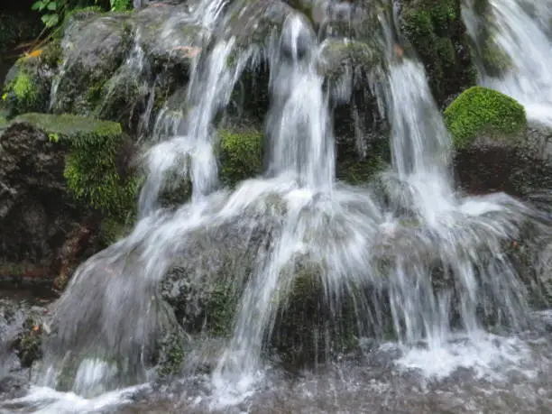 Steaming water of a cascade at Shirakawa fountainhead in Aso, Kumamoto in Japan.