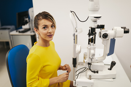 Portrait of young female ophthalmologist at work place