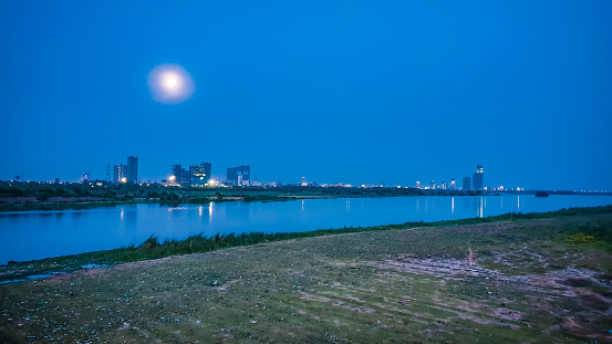 This pic is taken during lockdown in India. It was a supermoon day. Yamuna is one of the most polluted river of the world. But twentyone days lockdown made it much cleaner that it can reflect the skylight. In usal days you will see 2-5 layer of chemical fogg, that was flushed by nearby factories.