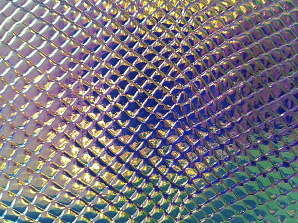 istock A shiny neon colored surface with many small cells of different sizes. Concept texture, background. 1219634334