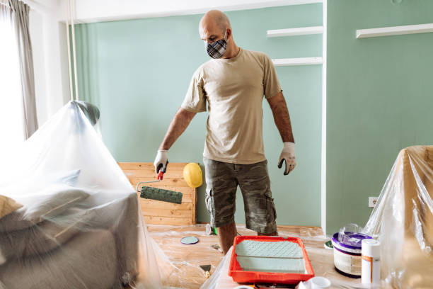 istock Mature man painting the living space 1219635262