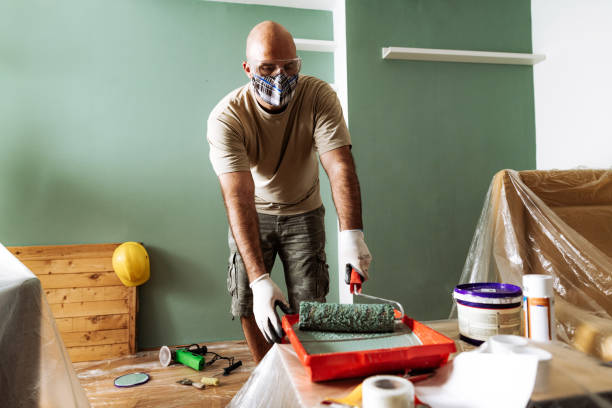 Renovation at home - man preparing the paint for second coat