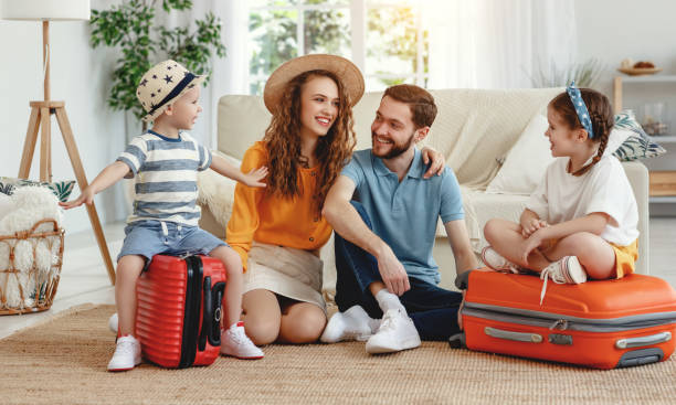 istock Cheerful family with suitcases on floor 1219639294