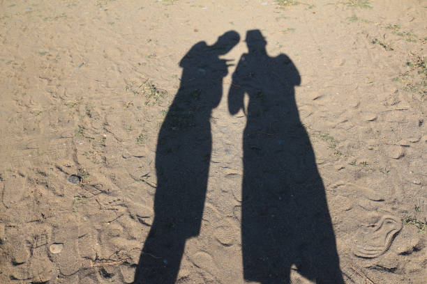 Shadow of two men on the sand at the beach. Turkey