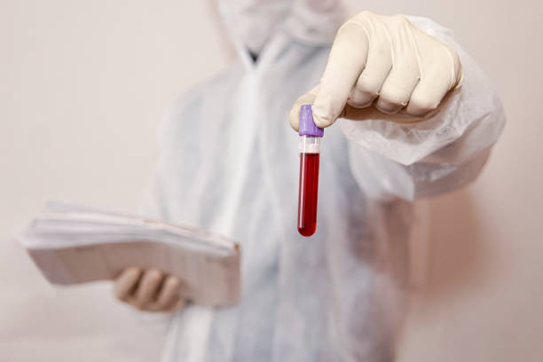 Hand with latex glove holding blood sample vial. male laboratory assistant holding a red test tube with blood on a white background. Blood, DNA, and RNA testing. Search for viruses in the blood. S Hand with latex glove holding blood sample vial. A male laboratory assistant holding a red test tube with blood on a white background. Blood, DNA, and RNA testing. Search for viruses in the blood. S crista ampullaris photos stock pictures, royalty-free photos & images