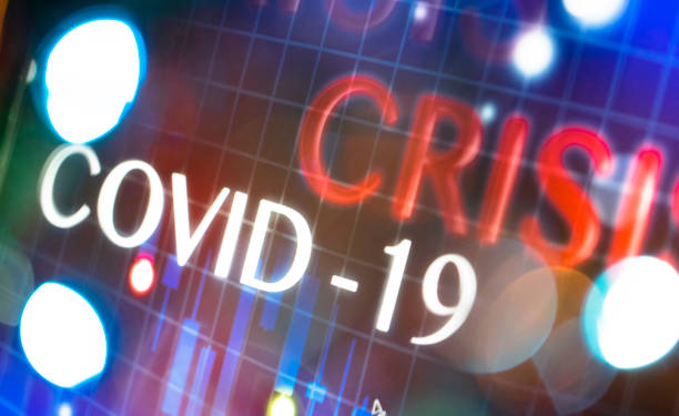 istock Words crisis and COVID-19 on the digital display. 1219642125
