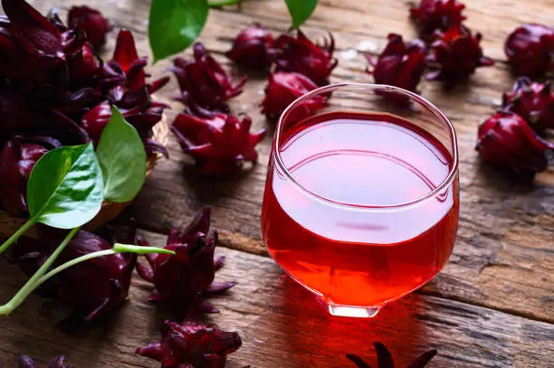 Photo of Roselle juice on wooden background, herbal organic tea for good healthy