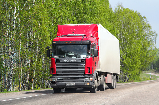 Sverdlovsk Region, Russia - May 8, 2012: Red semi-trailer truck Scania R380 at the interurban road.