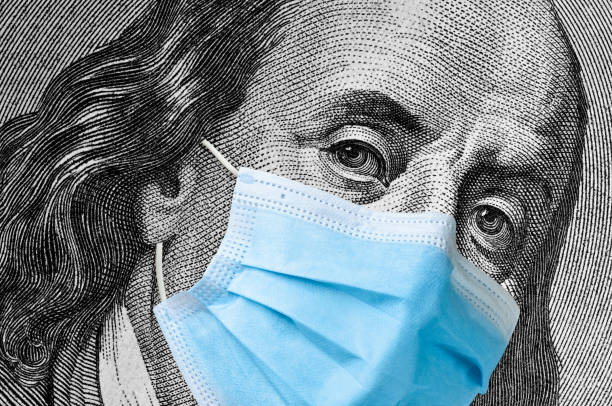 istock One hundred dollar bill with medical face mask on Benjamin Franklin. 1219647581