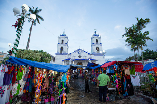 Lake Catemaco, Veracruz/Mexico - January 2, 2019: City life flourishes in the spaces around Basílica de Nuestra Señora del Carmen.